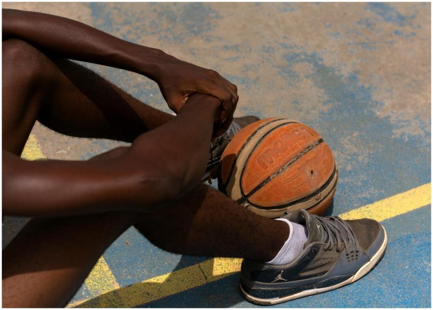 Close-up of a basketball player sitting on an outd
