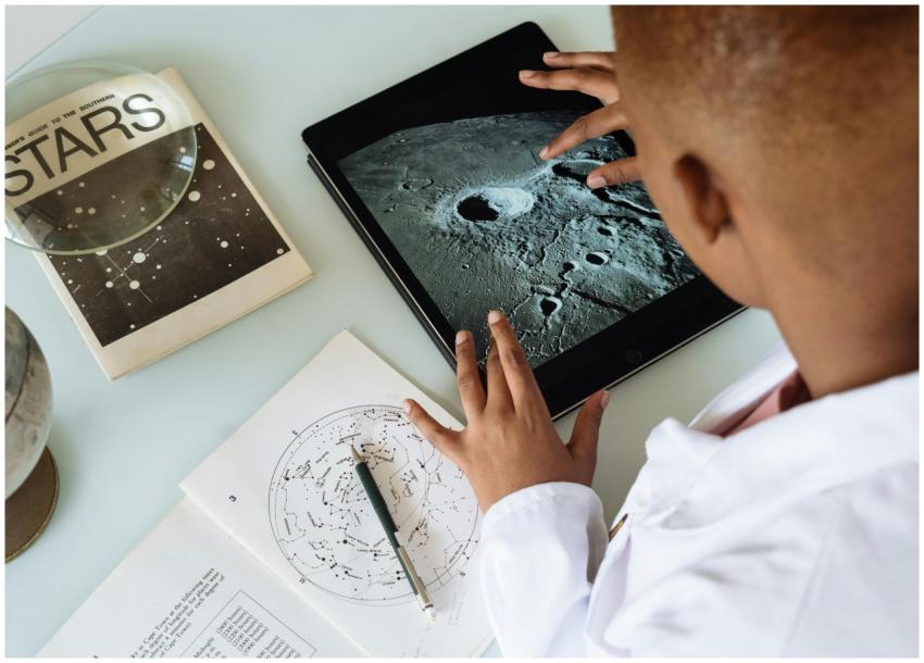 Child exploring moon craters on tablet surrounded