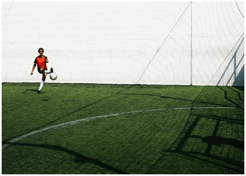 Young African American female football player tryi