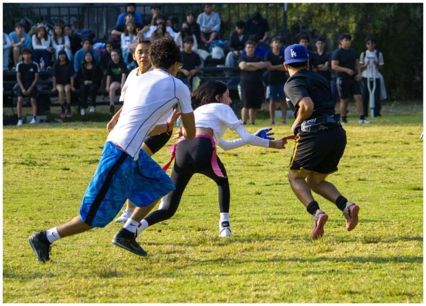 A group of teenagers playing a competitive field g