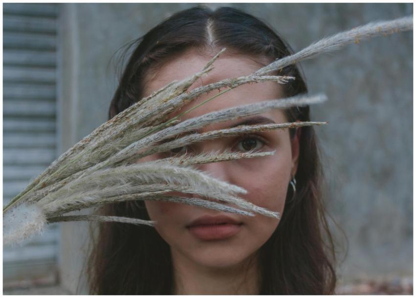 Artistic portrait of a woman with grass stalks obs