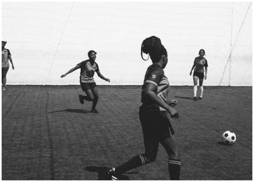 Female soccer players competing in an outdoor matc
