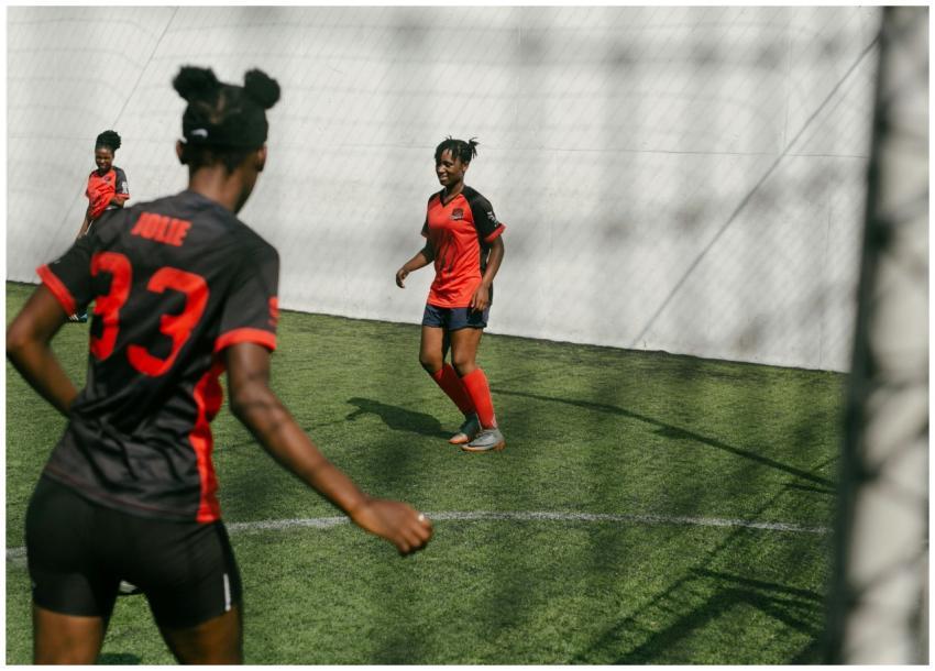 Female soccer players practicing on an outdoor gra