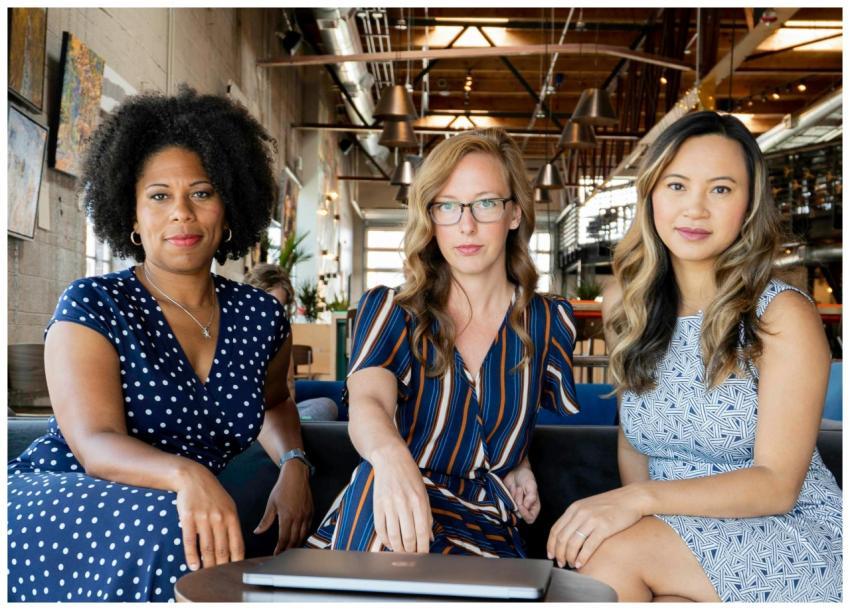 Three professional women sitting confidently in a