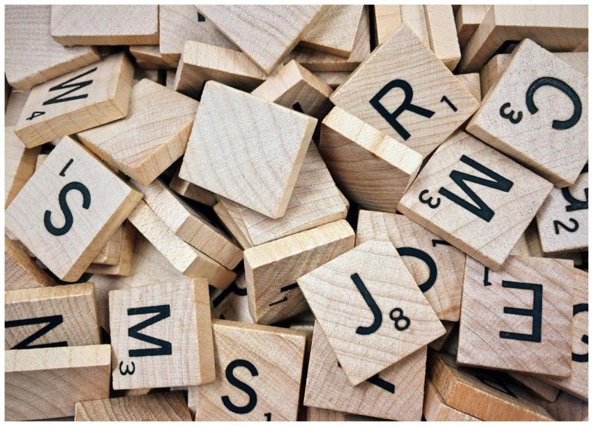 A collection of wooden Scrabble tiles with letters