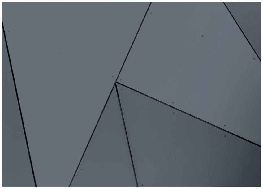 Abstract geometric facade with grey panels and sha