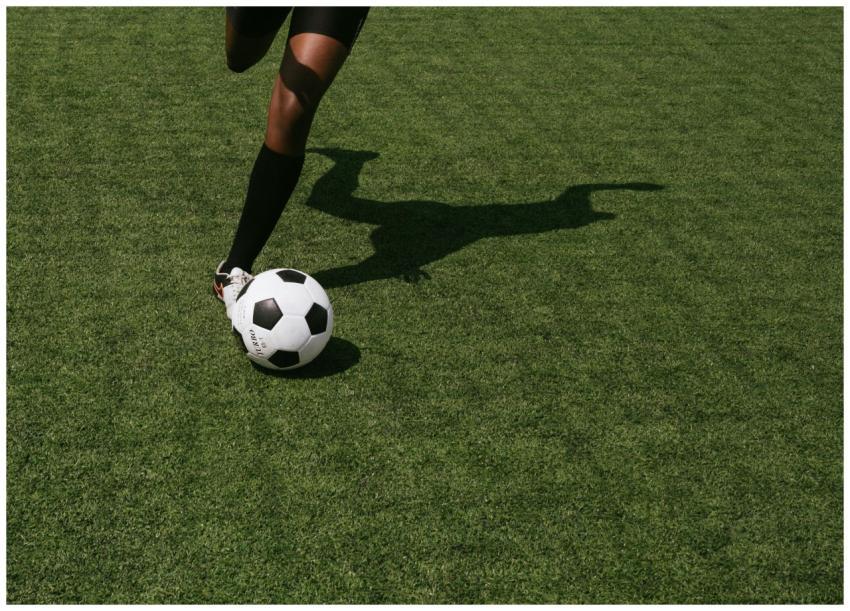 Cropped shot of a soccer player in motion, perform