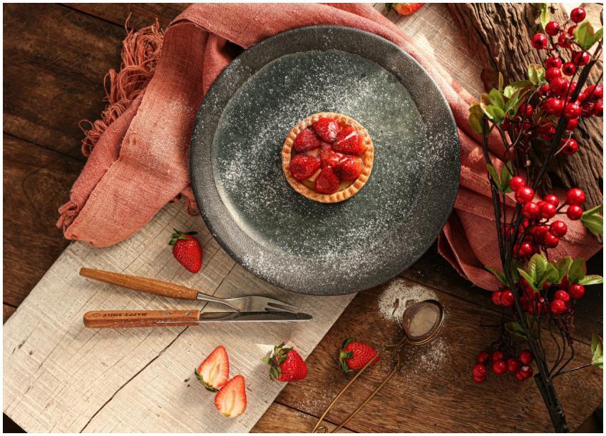 A delicious strawberry tart dusted with powdered s