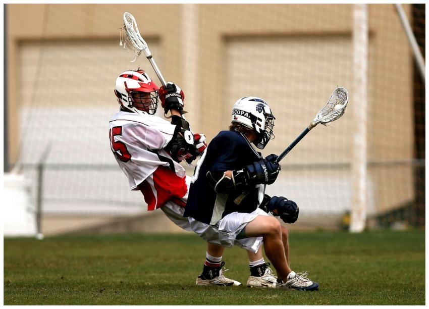 Dynamic action shot of two male lacrosse players c