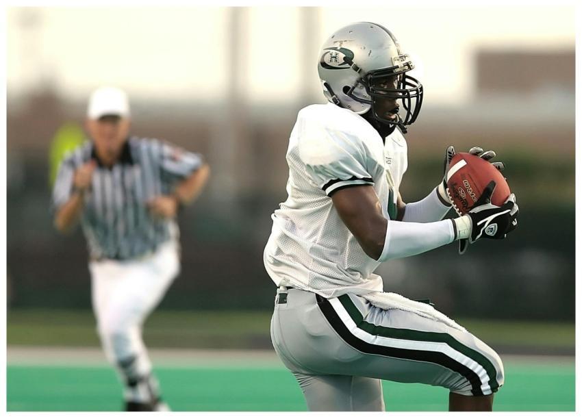 Dynamic action shot of a football player catching