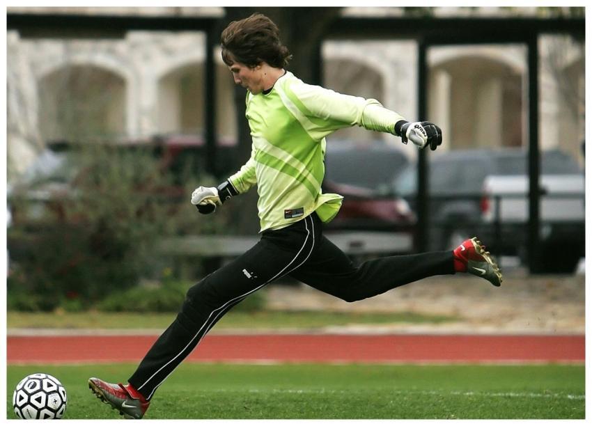 Dynamic shot of a soccer player in motion, kicking