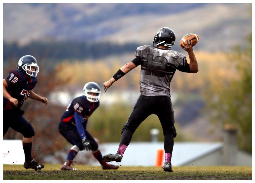 Athletes competing in an intense American football