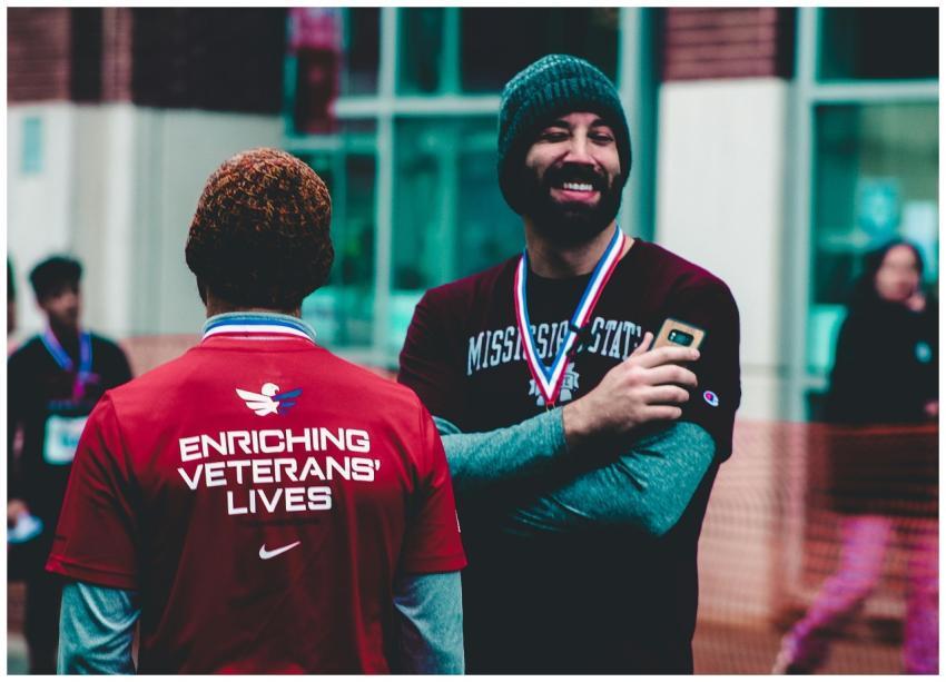Two men sharing a light moment at a charity event
