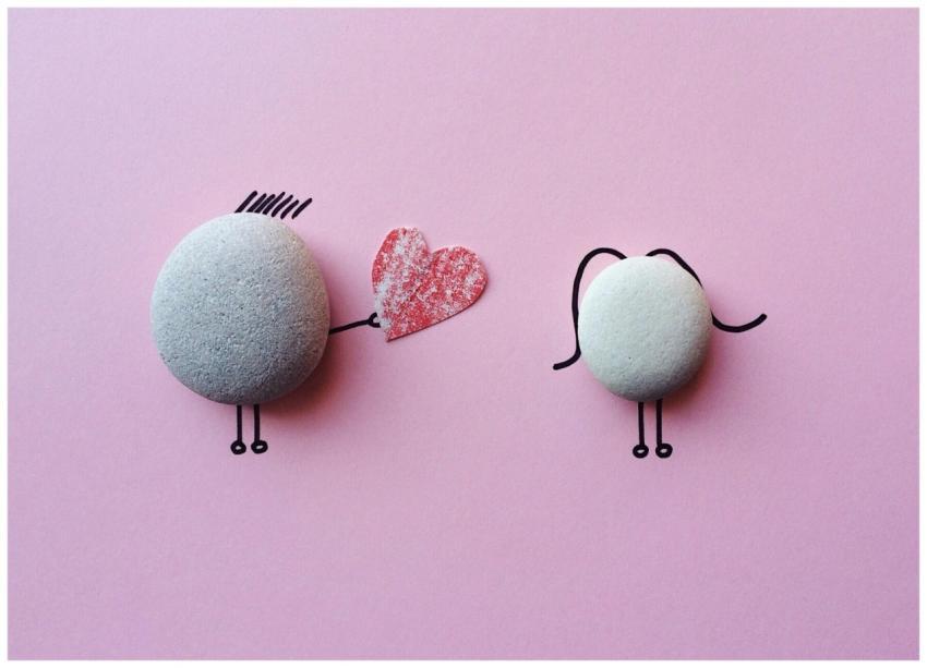 Charming stone art with heart symbol on pink backg