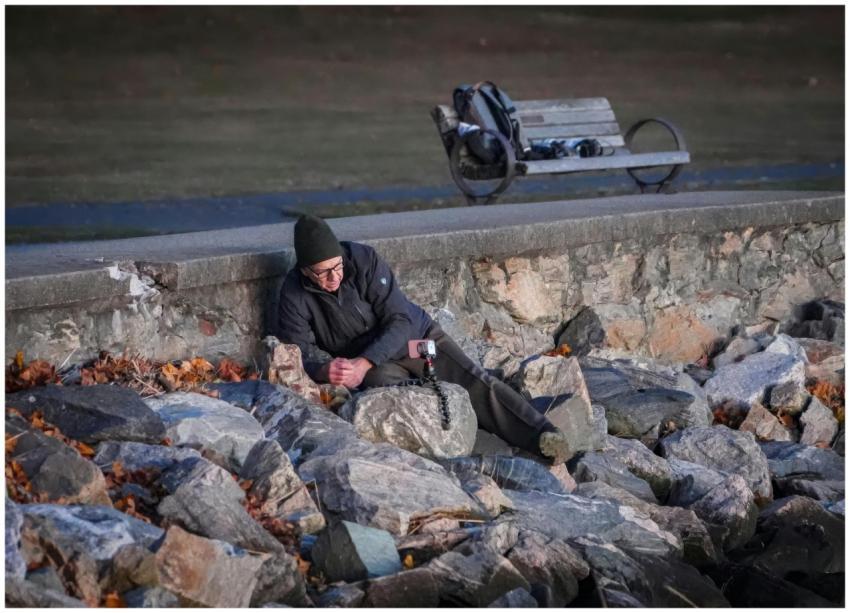 Man Relaxing Stone Wall