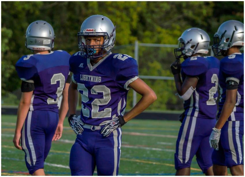 Young athletes in football uniforms ready for an o
