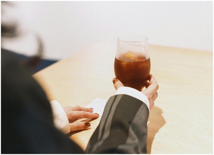 A stylish adult enjoying a cold drink in a modern
