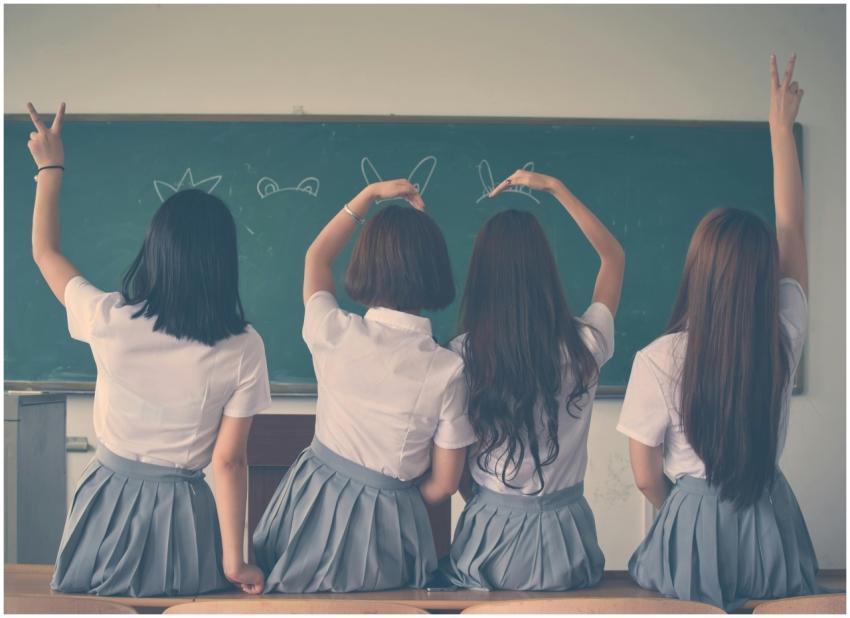 Group of teenage girls in school uniforms enjoying