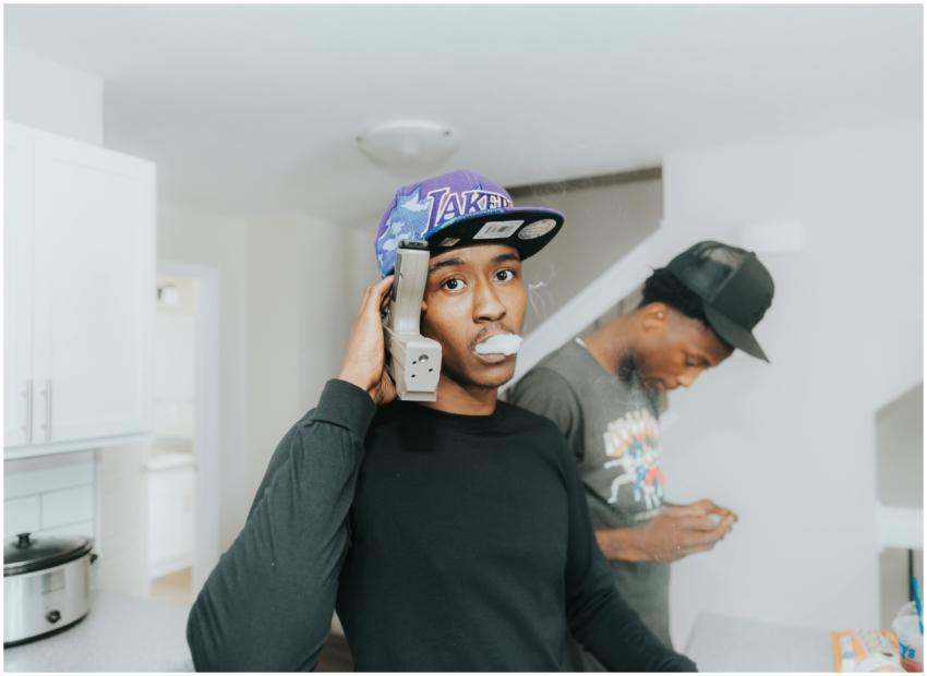 Two young men indoors in Omaha engaging in an arti