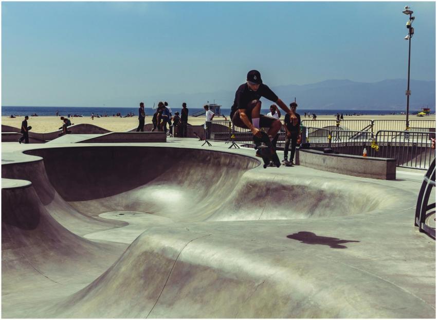 Skateboarder performing tricks at Venice Beach ska