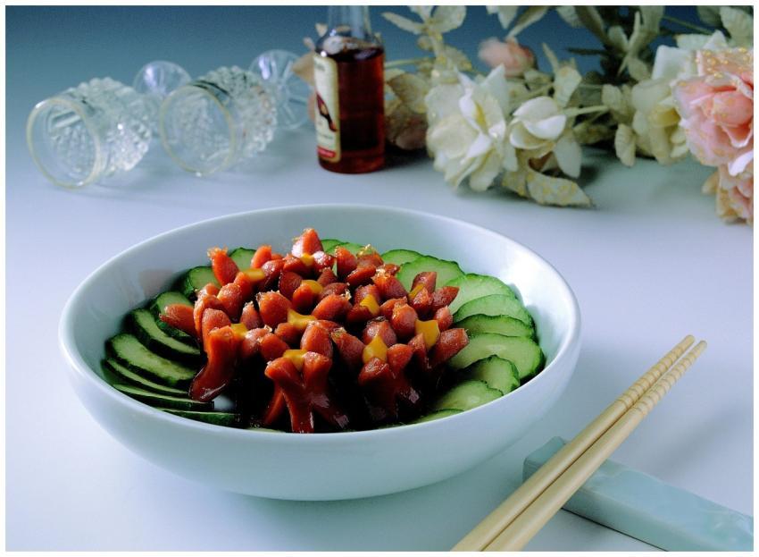 Vibrant salad bowl featuring sausages and cucumber