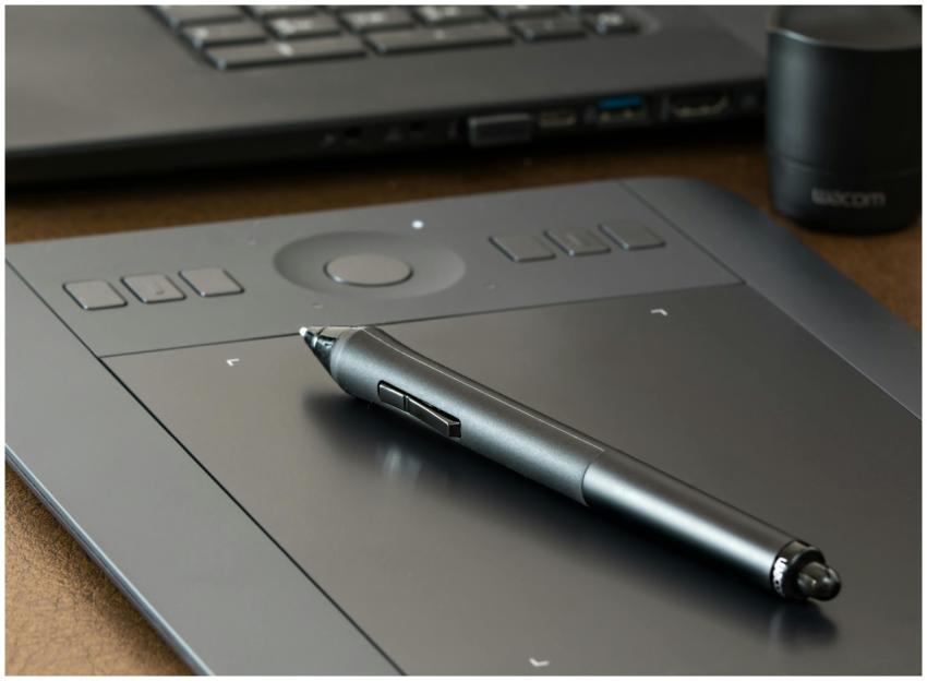 Close-up of a digital drawing tablet with a stylus