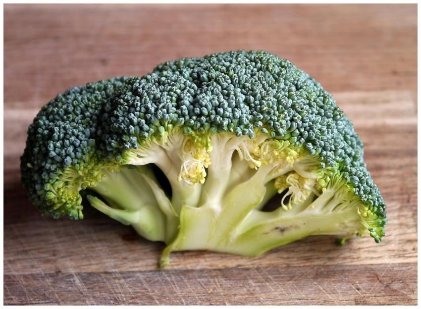 Fresh green broccoli close-up on a wooden cutting