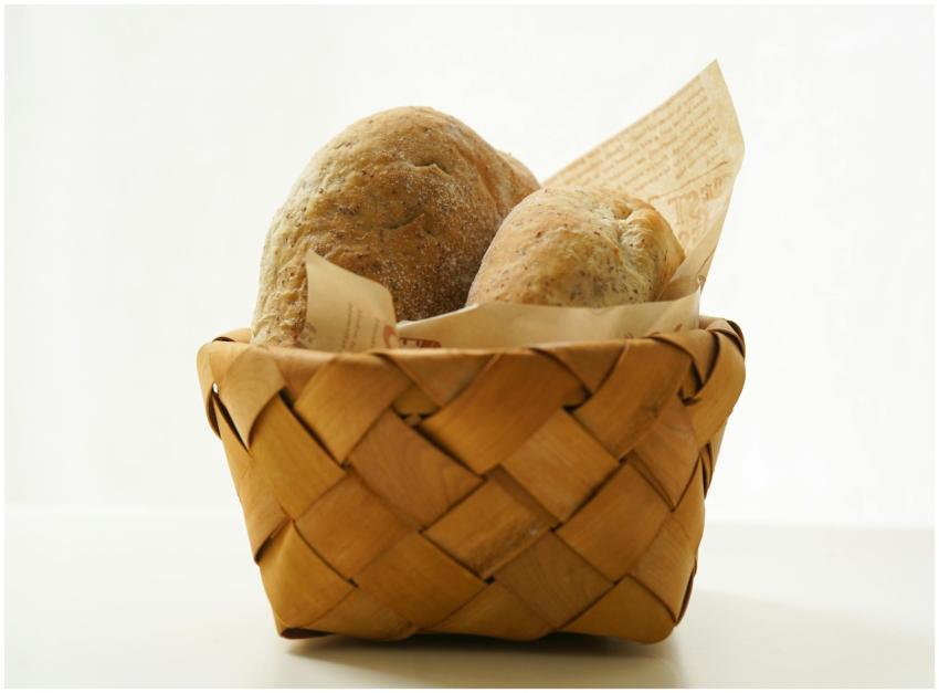 Artistic composition of fresh bread in a wicker ba