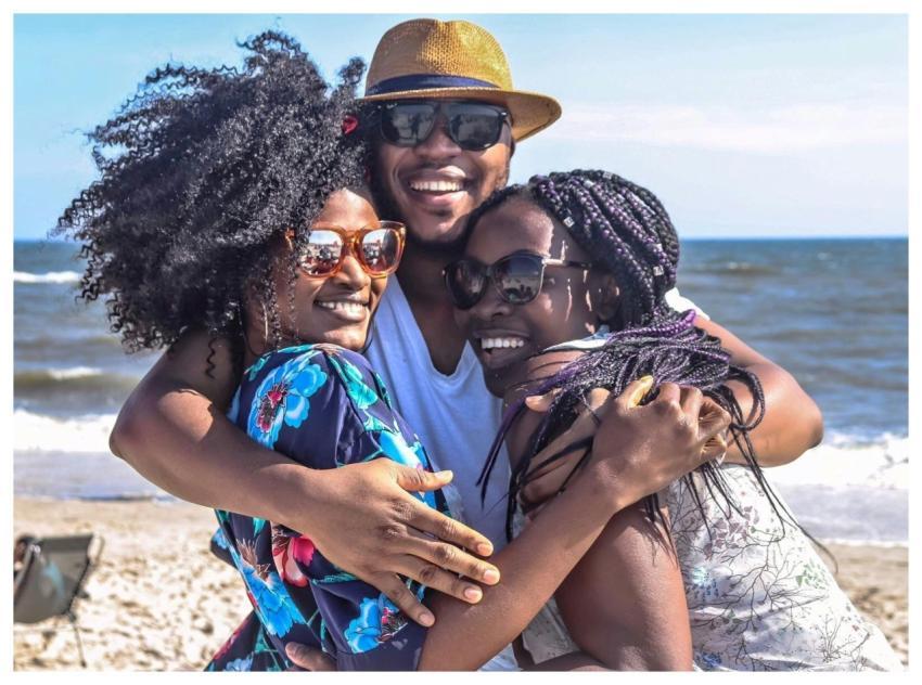 Three friends enjoying a sunny day at the beach, e
