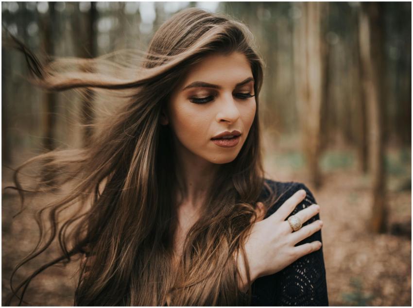 Portrait of a young woman with long hair, eyes clo
