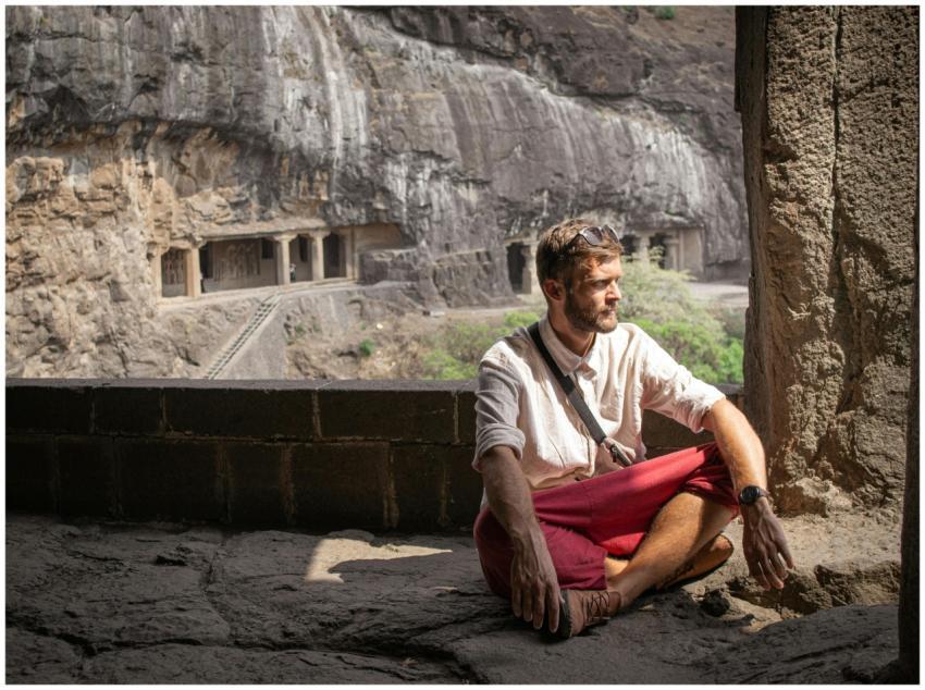 A man sitting in meditation at the historic Ellora
