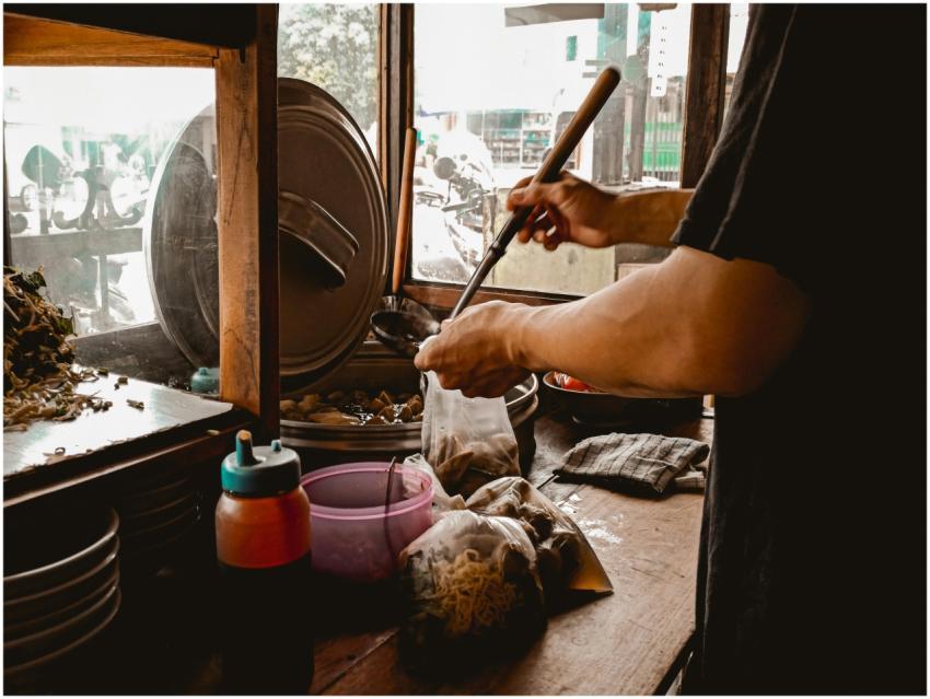 Street food vendor preparing a traditional Asian n