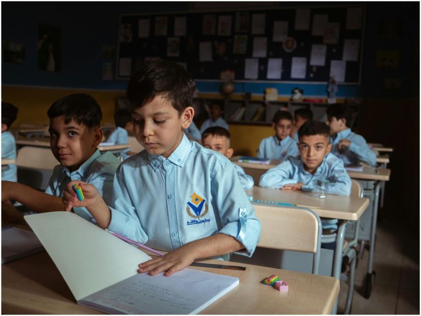 Group of boys in a classroom setting, focused on t