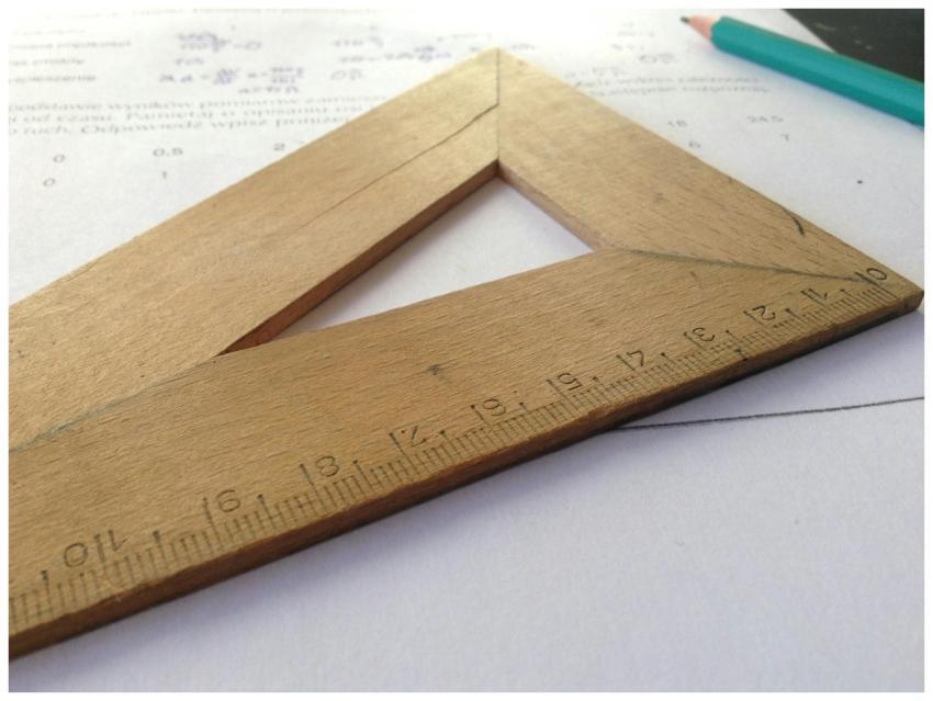 Close-up of a wooden ruler on paper, ideal for edu