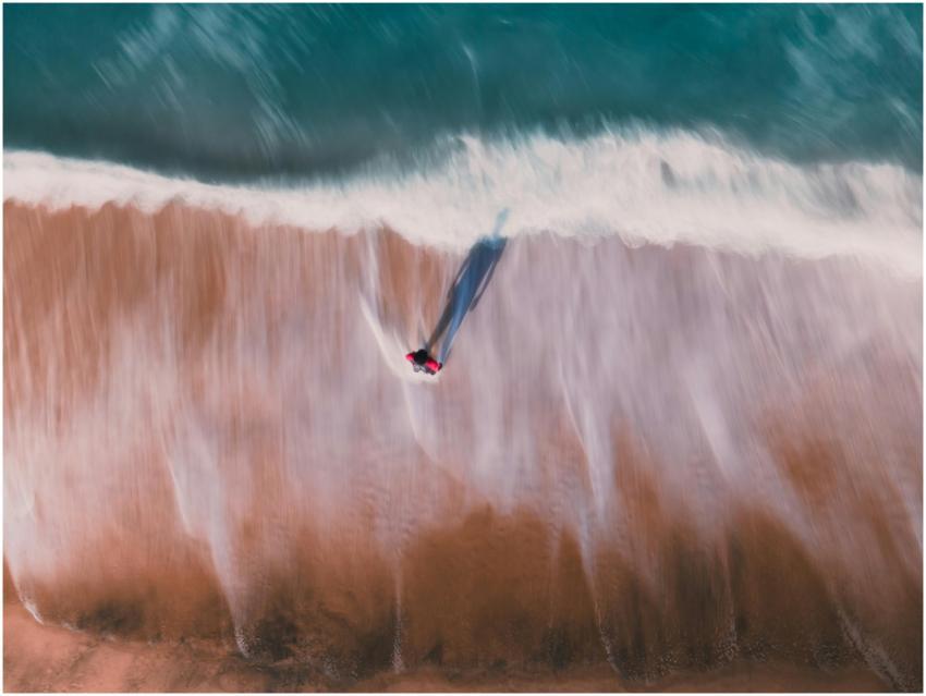 Aerial view of a solitary person walking along an