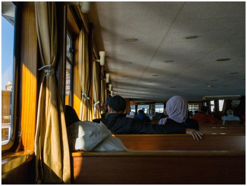 Passengers enjoy a peaceful ferry ride seated insi