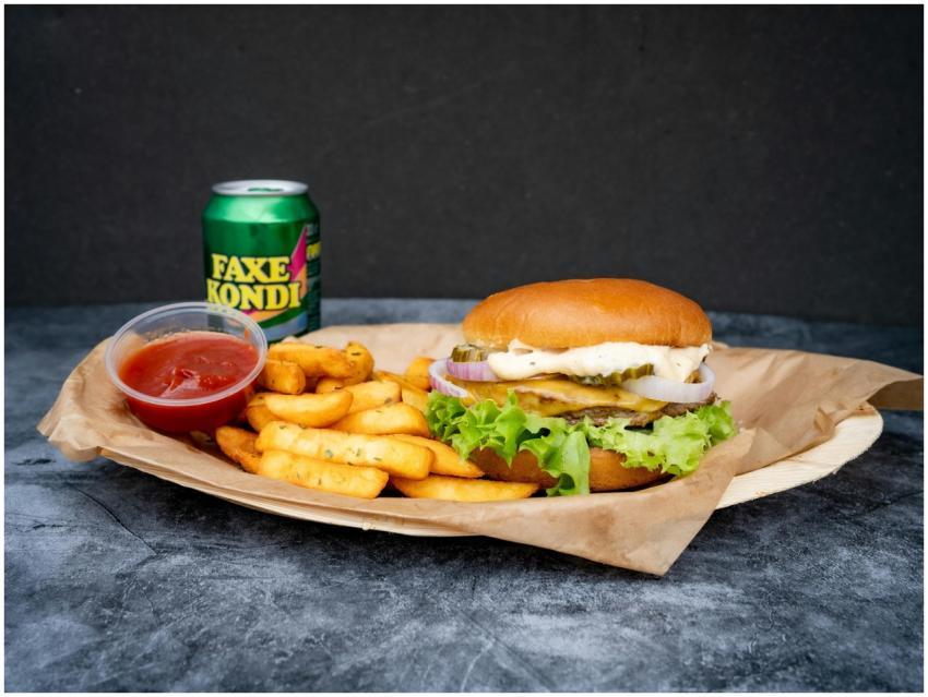 Close-up of a tasty burger and fries meal with Fax