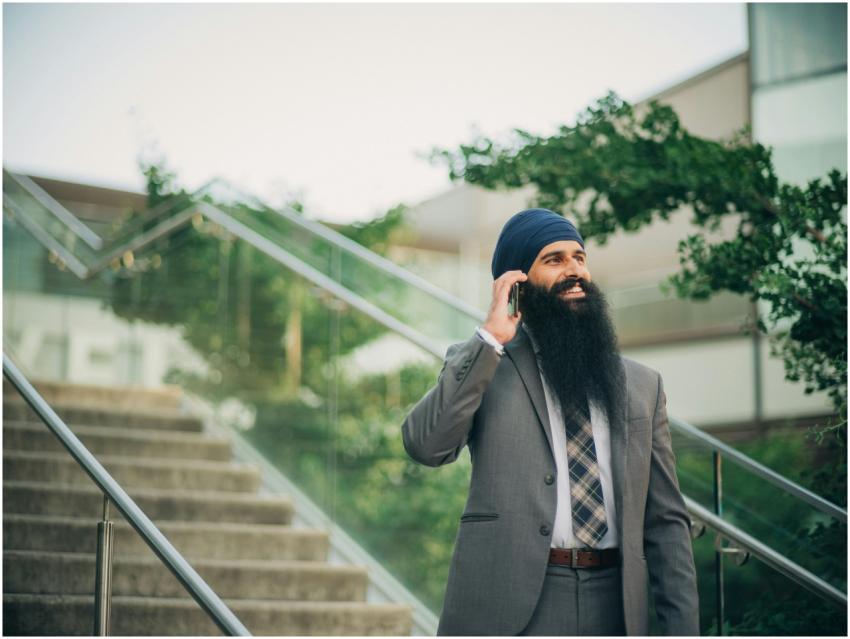 Smiling businessman with a beard and turban talks