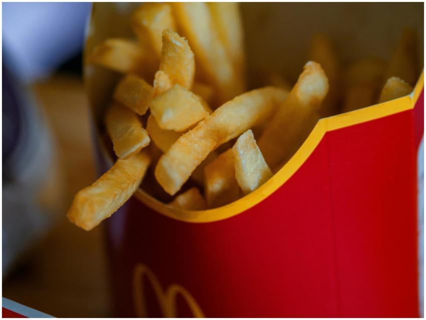 Delicious golden french fries in a red box, perfec