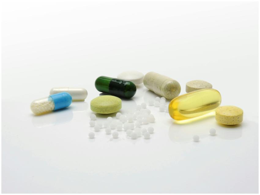 Close-up of various pills and capsules on a white