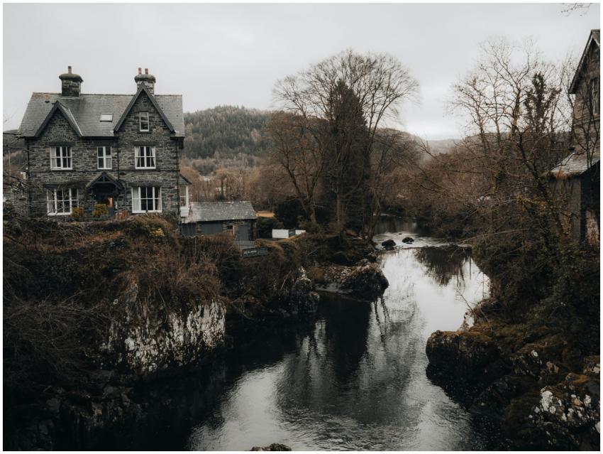 Picturesque old stone house by a tranquil river in