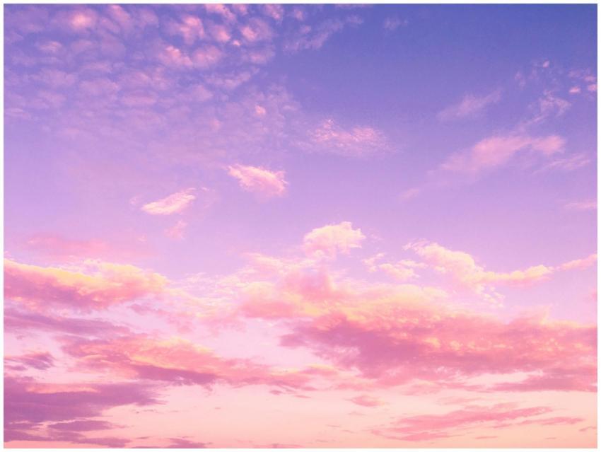 A dreamy pink and purple cloud-filled sky at sunse