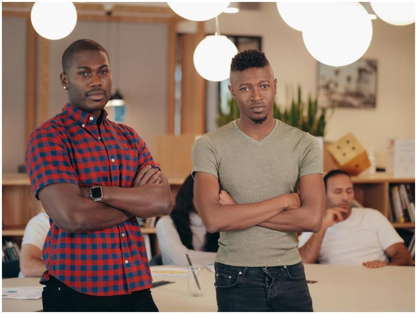 Confident men with arms crossed posing in a contem
