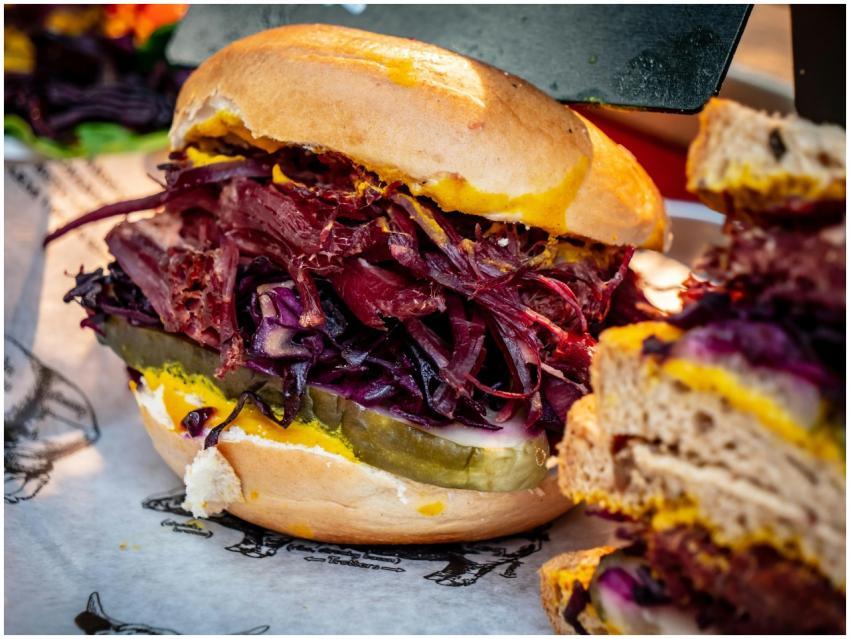 A juicy sandwich featuring fresh vegetables and fl