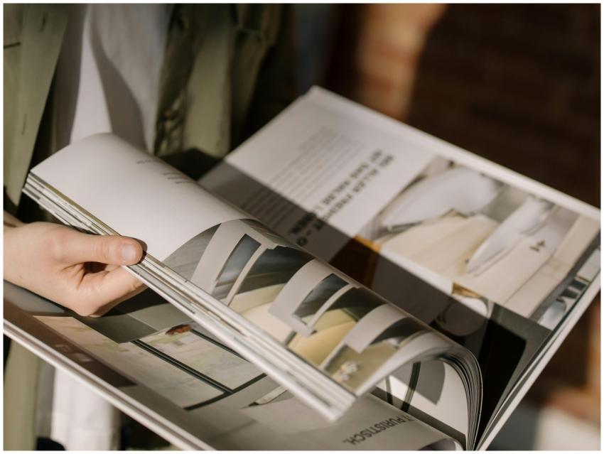 Close-up of hands turning pages in a modern archit
