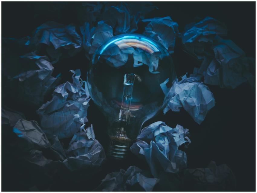 A light bulb surrounded by crumpled paper symboliz