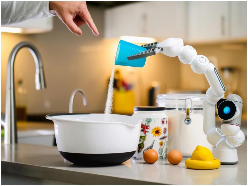 A robot arm assists in baking by pouring ingredien