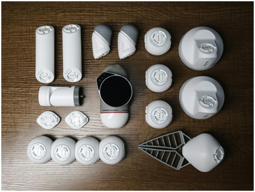 Assorted robotics parts arranged neatly on a woode