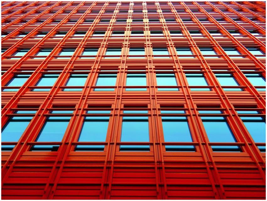 Low angle shot of a modern red building with glass