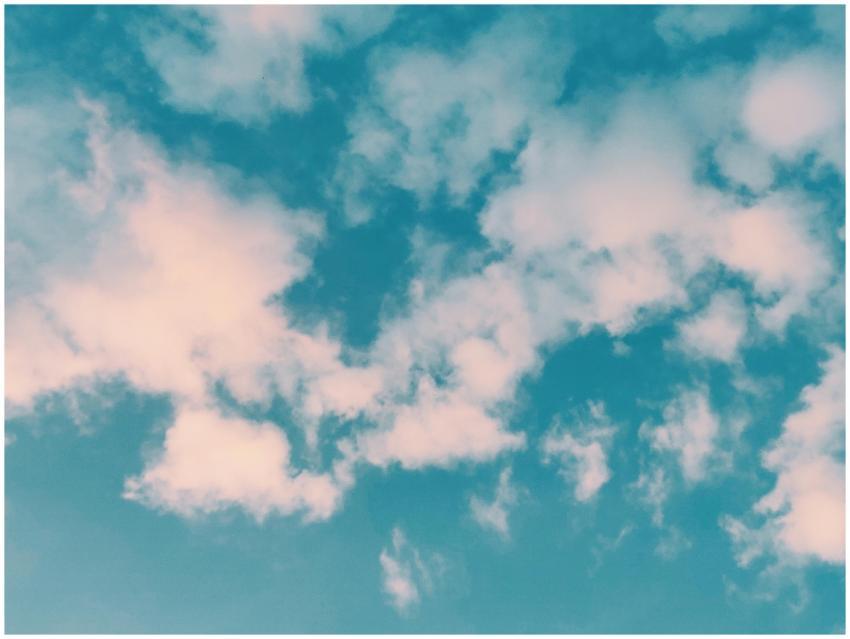 A serene view of fluffy white clouds scattered acr